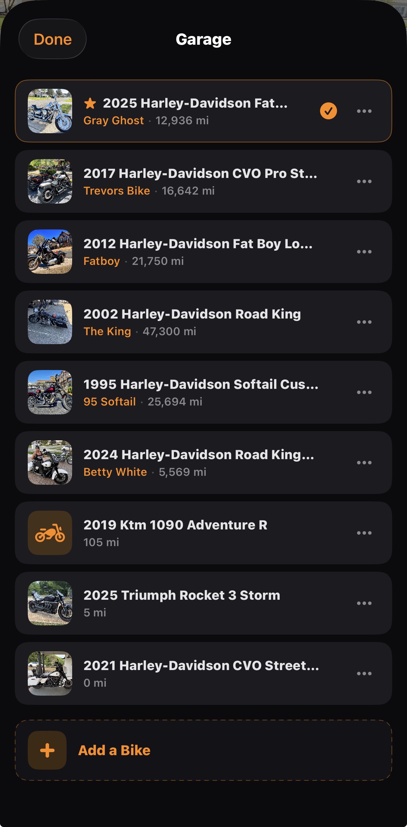 Garage showing 8 motorcycles with names, photos, and mileage